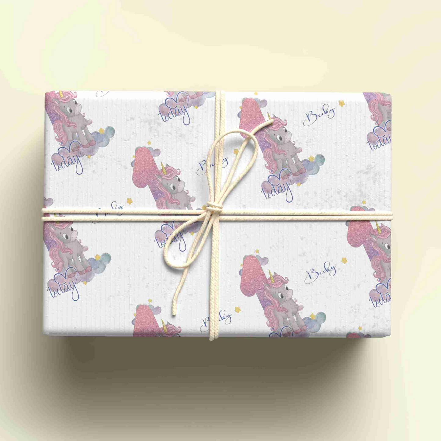 a gift wrapped in a white wrapping paper with a pink bear on it