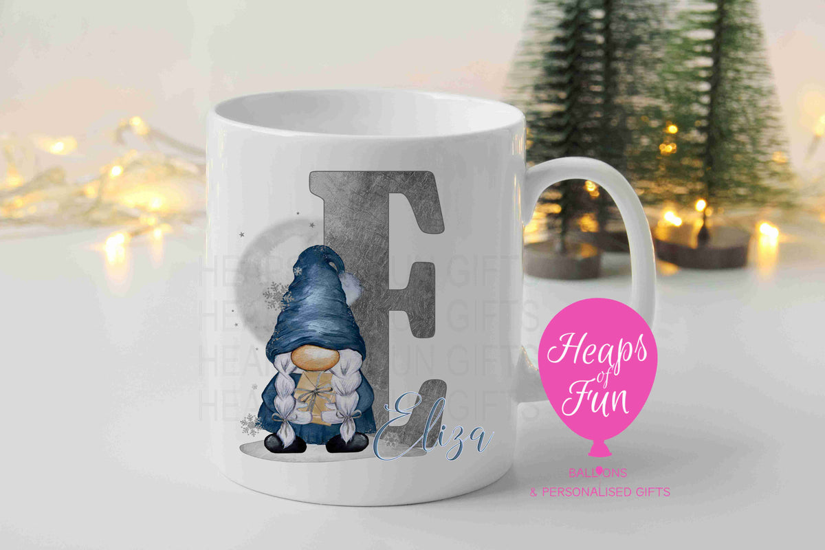 Personalised Christmas mug with navy girl gnome holding a present, silver initial and name