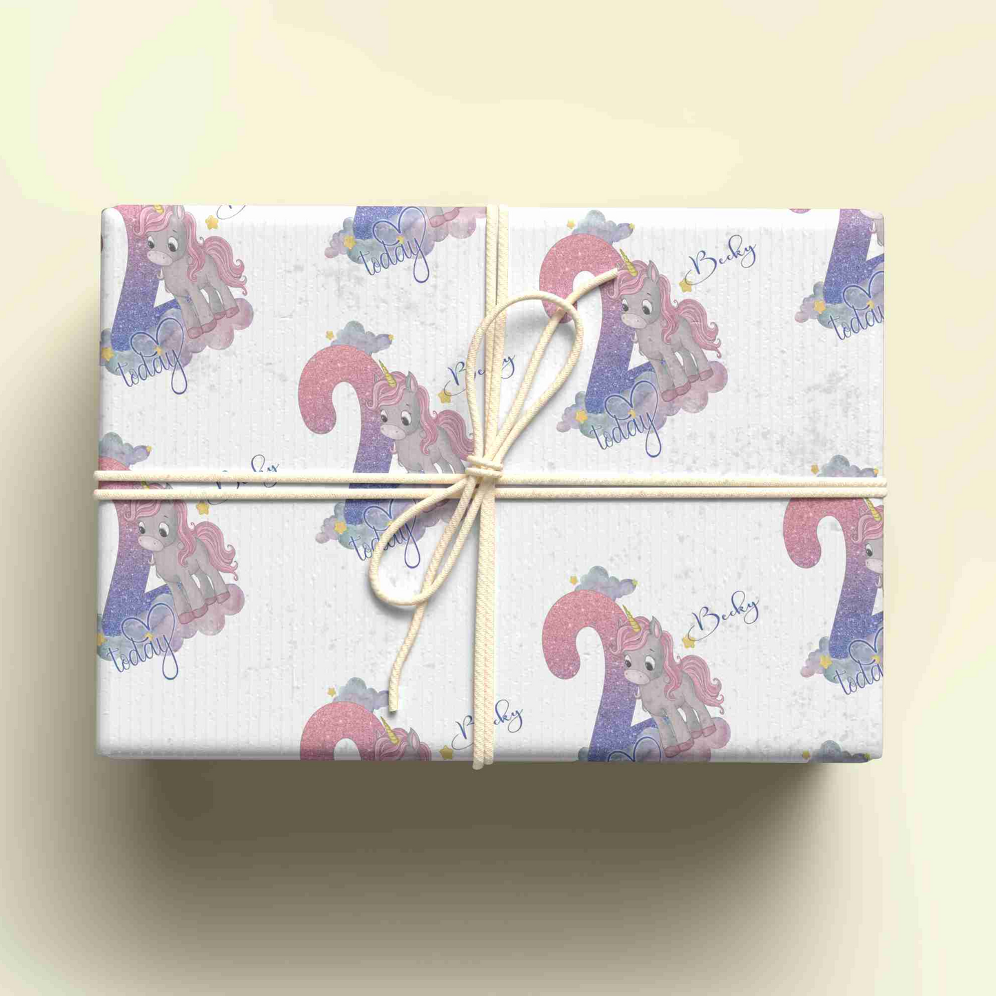 a gift wrapped in a white wrapping paper with a pink pony on it