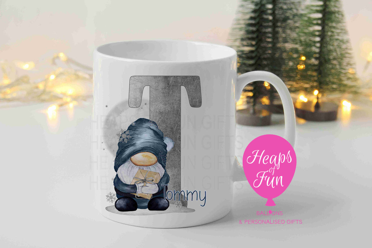 Personalised Christmas mug with navy boy gnome holding a present, silver initial and name