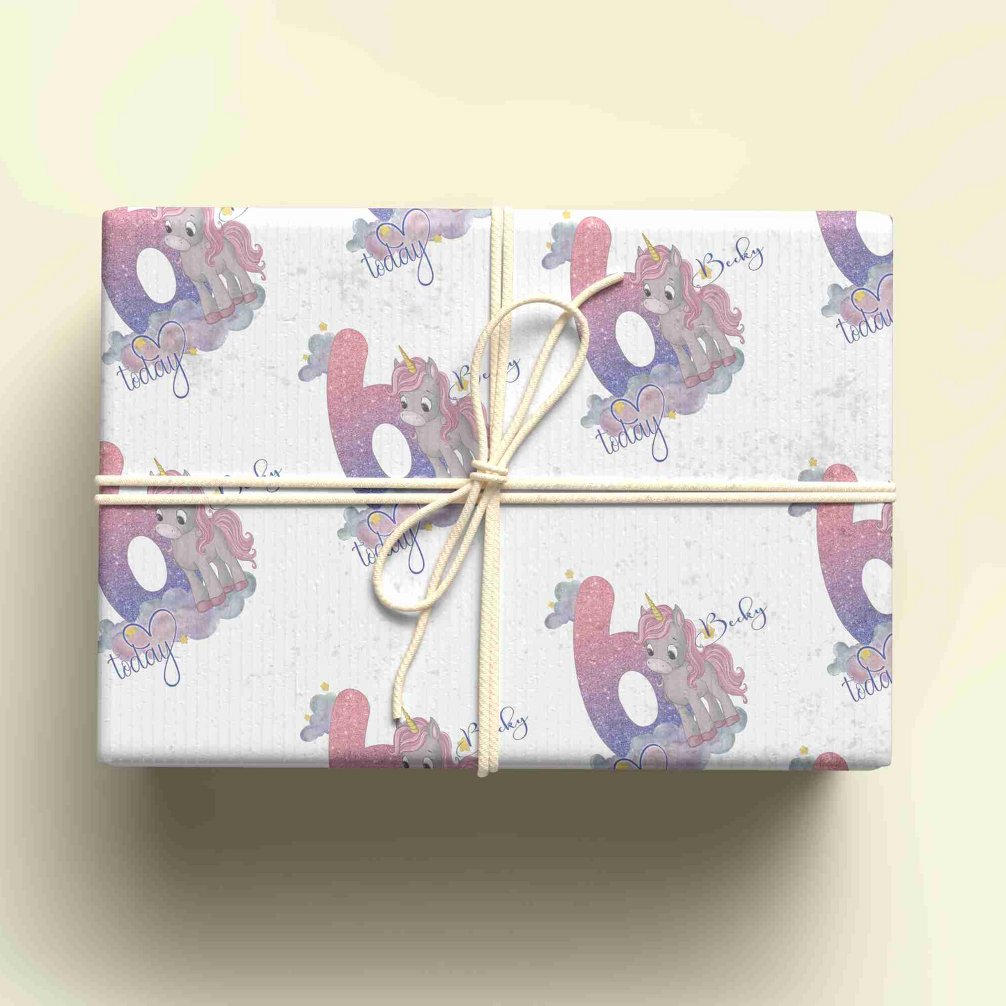 a wrapped gift box with a unicorn design on it