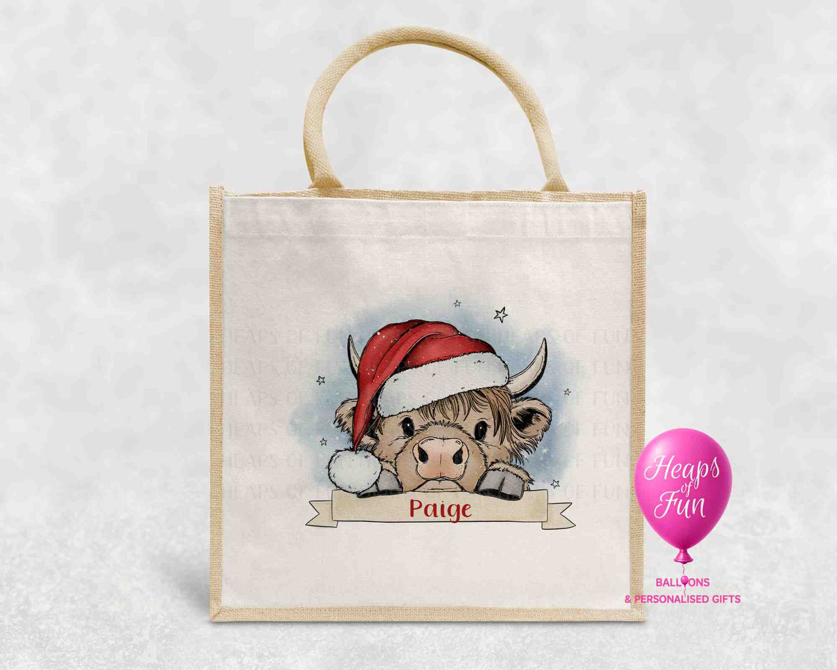 Personalised Highland cow Christmas jute bag with Santa hat and name banner