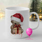 Personalised brown teddy bear Christmas mug with Santa hat, present and name