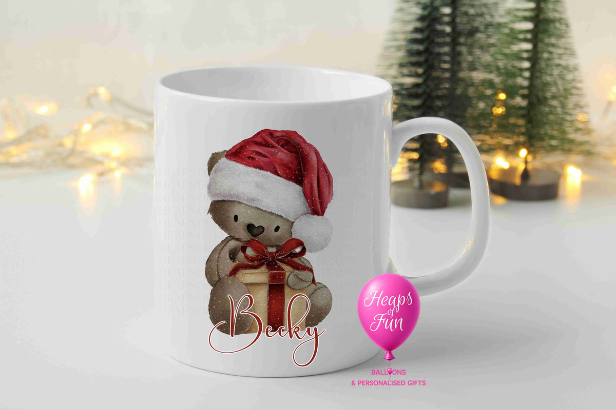 Personalised brown teddy bear Christmas mug with Santa hat, present and name