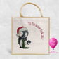Tis the Season to be Jolly Christmas jute bag with watercolour penguin in Santa hat and festive garland