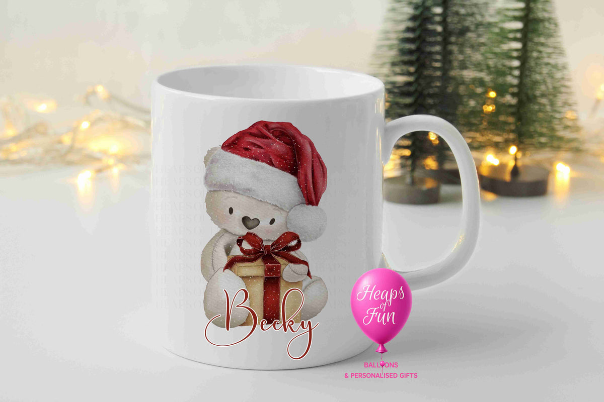 Personalised cream teddy bear Christmas mug with Santa hat, present and name