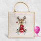 Personalised Christmas jute bag with cartoon reindeer holding red glitter initial and name