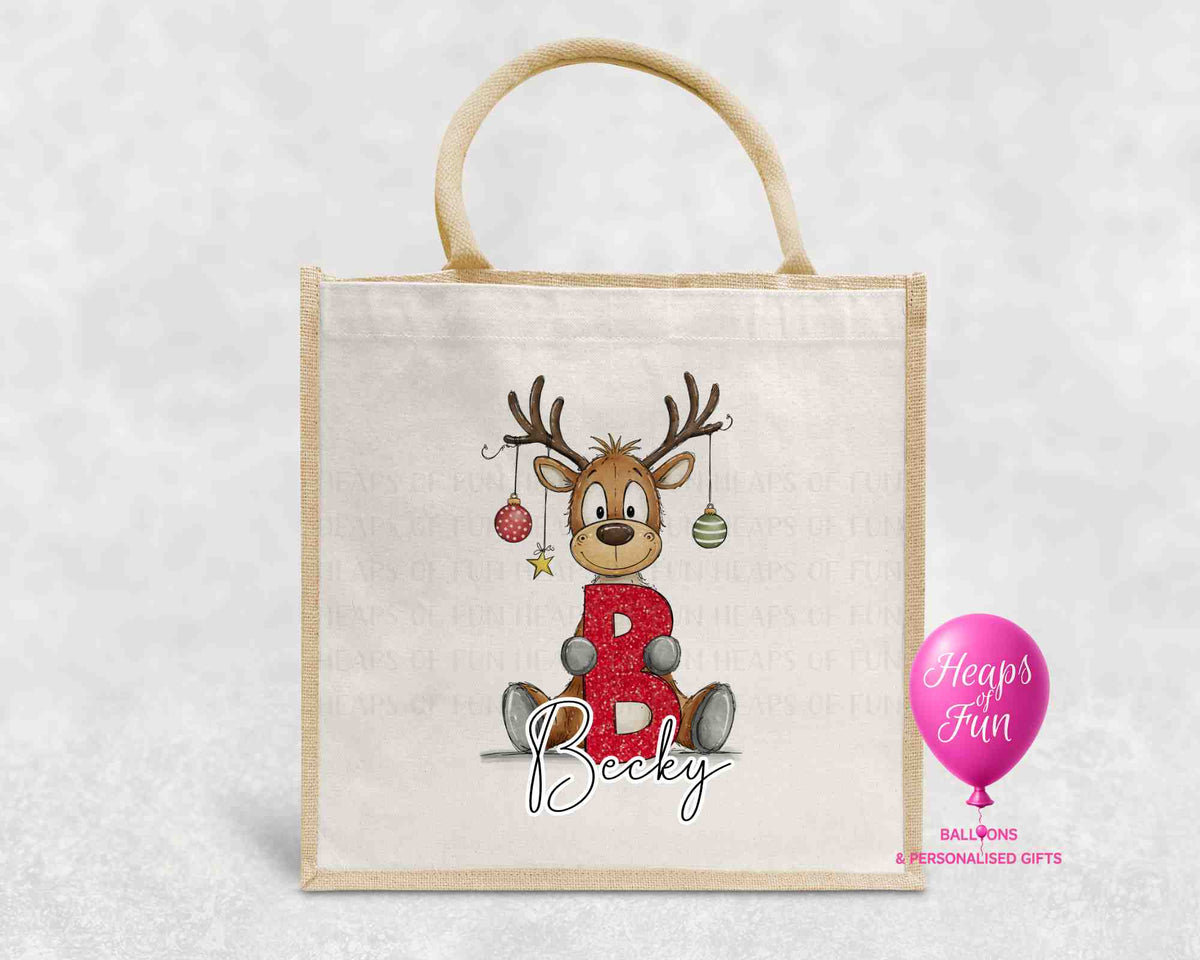 Personalised Christmas jute bag with cartoon reindeer holding red glitter initial and name