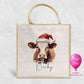 Personalised Christmas jute bag with watercolour brown and white cow in Santa hat and name