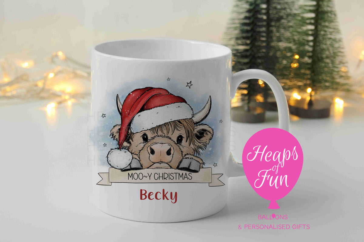Personalised Highland cow Christmas mug in Santa hat with Moo-y Christmas banner and name
