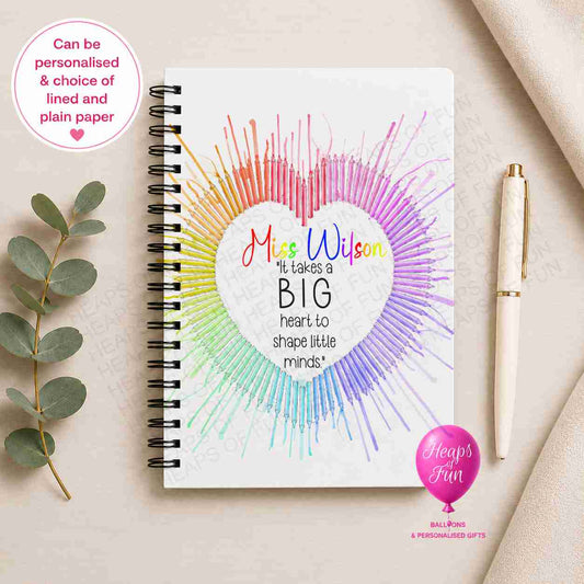 Personalised spiral-bound teacher notebook featuring a colourful heart made from rainbow pencils with the quote "It Takes a Big Heart to Shape Little Minds", customised with the teacher's name and available with lined or plain pages.