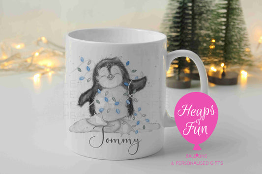 Personalised penguin Christmas mug with blue fairy lights and name