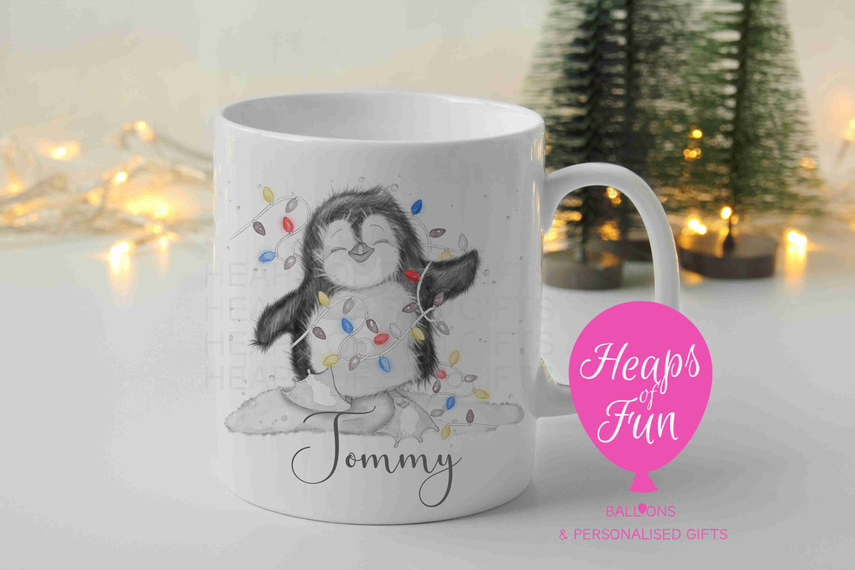 Personalised penguin Christmas mug with multicoloured fairy lights and name