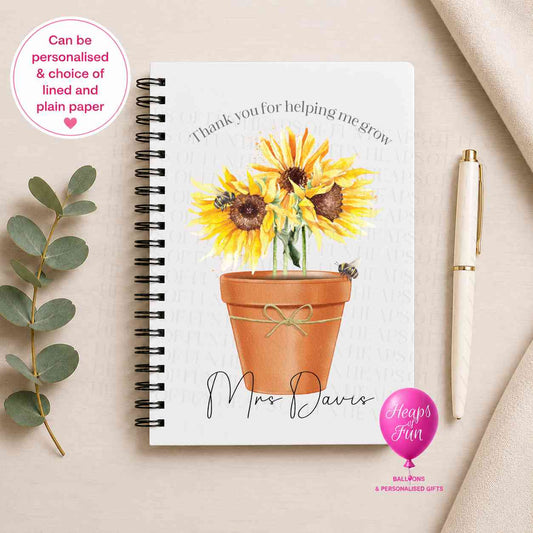 Personalised spiral-bound teacher notebook featuring a sunflower plant in a flower pot with the message "Thank You for Helping Me Grow", customised with the teacher's name and available with lined or plain pages as a thoughtful teacher appreciation gift.