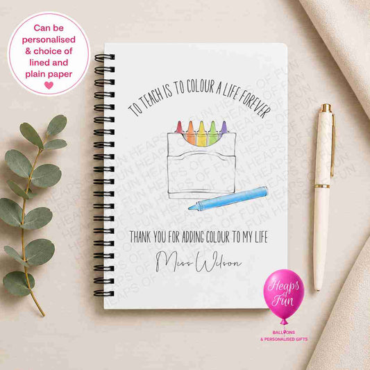 Personalised spiral-bound teacher notebook featuring a colourful crayon illustration with the message "To Teach is to Colour a Life Forever – Thank You for Adding Colour to My Life", customised with the teacher's name and available with lined or plain pages